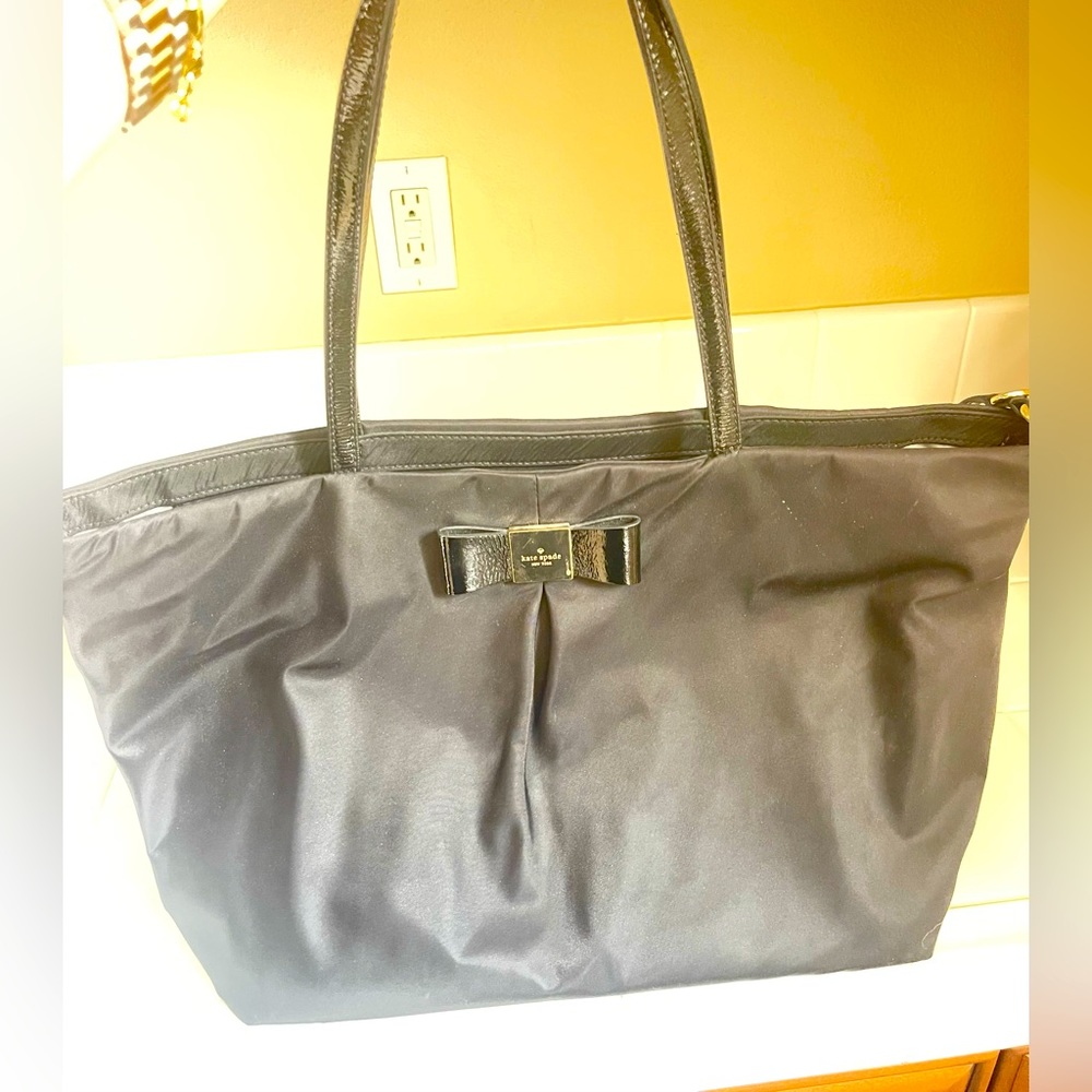 Black nylon Kate Spade diaper bag with patent leather handles/accents.